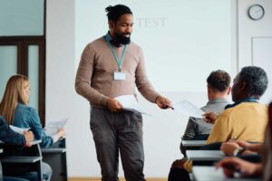 Lecturer handing out some notes in class