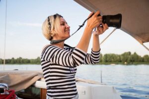 Woman taking a photograph from a boat