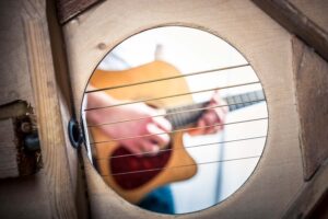 View of someone playing an acoustic guitar