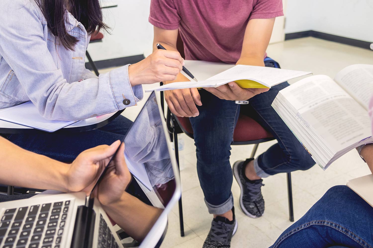 Students in a group working on assignments